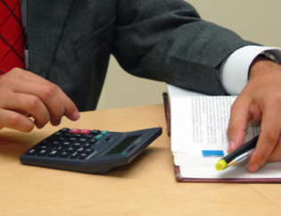 Construction manager reviewing prevailing wage determination time and PERM timeline planning on laptop.