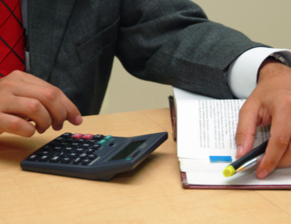 Construction manager reviewing prevailing wage determination time and PERM timeline planning on laptop.