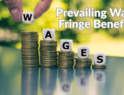 Construction contractor reviewing prevailing wage fringe benefits and certified payroll compliance calculations on a job site.